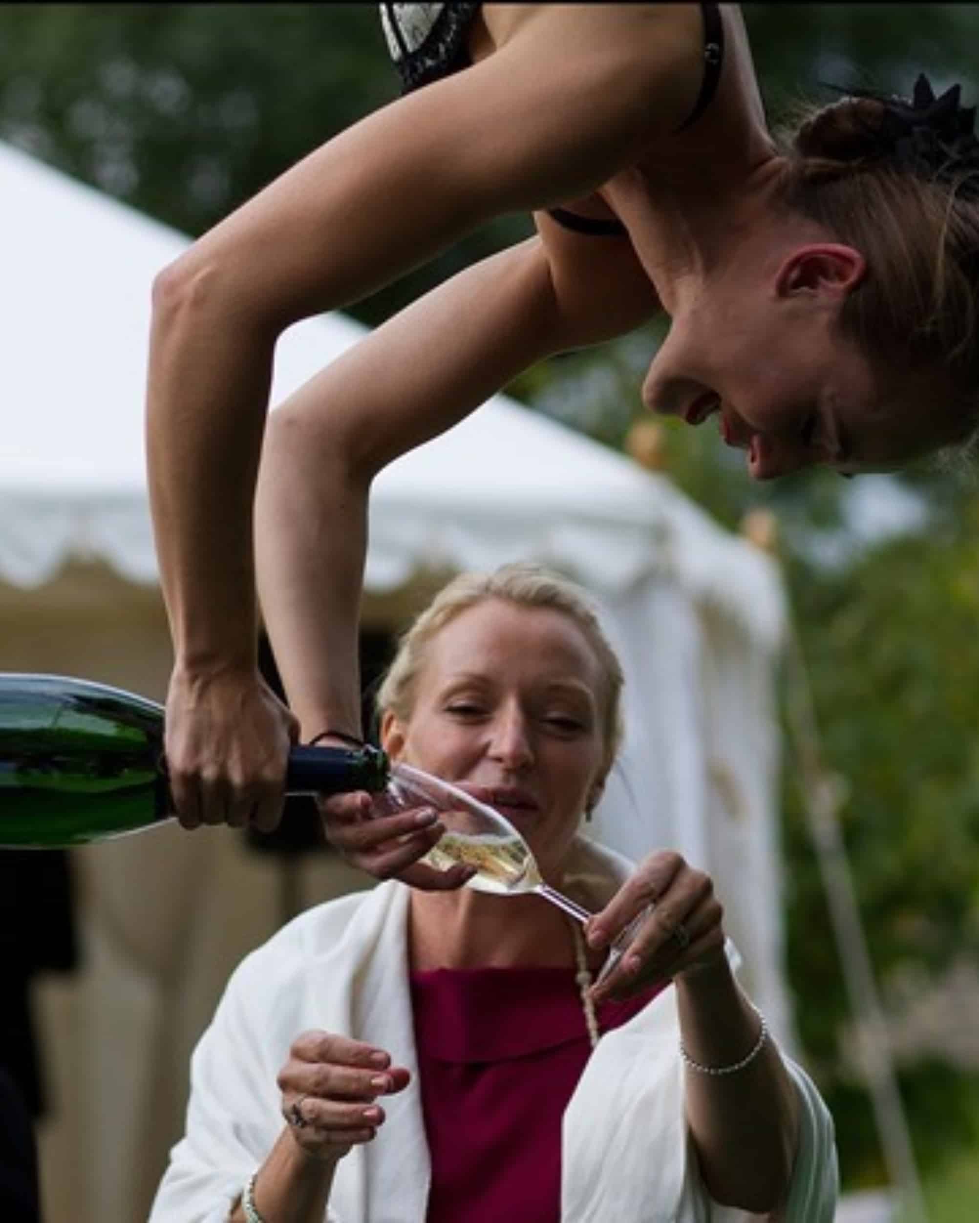 Aerial artist pouring champagne