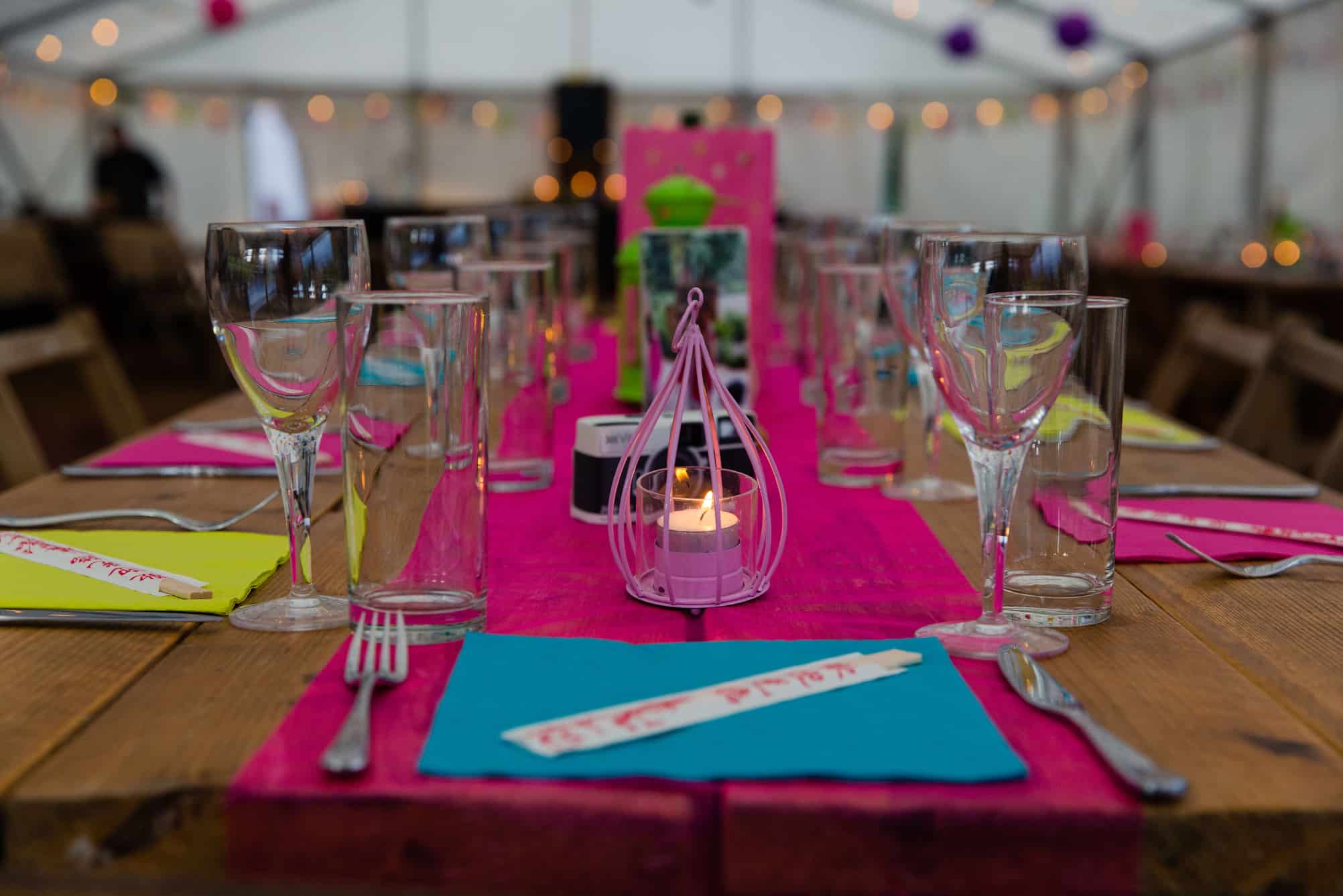 colourful tables setting within a marquee
